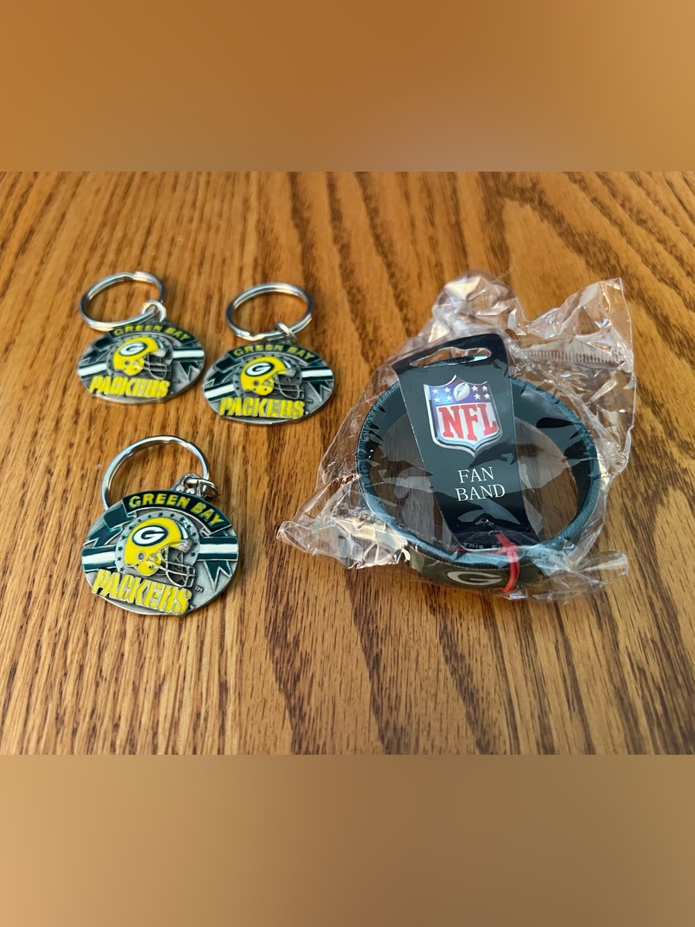 Green Bay Packers 3 Keychain and One NFL Fan Band Set